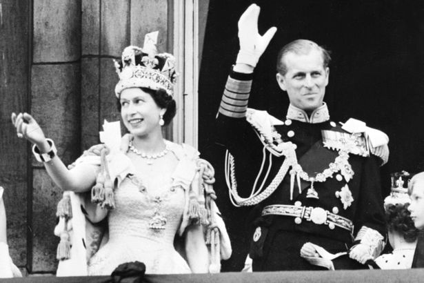 Queen+Elizabeth+II+accompanied+by+Prince+Philip+waves+to+the+crowd,+02+June+1953+after+her+coronation+.jpg