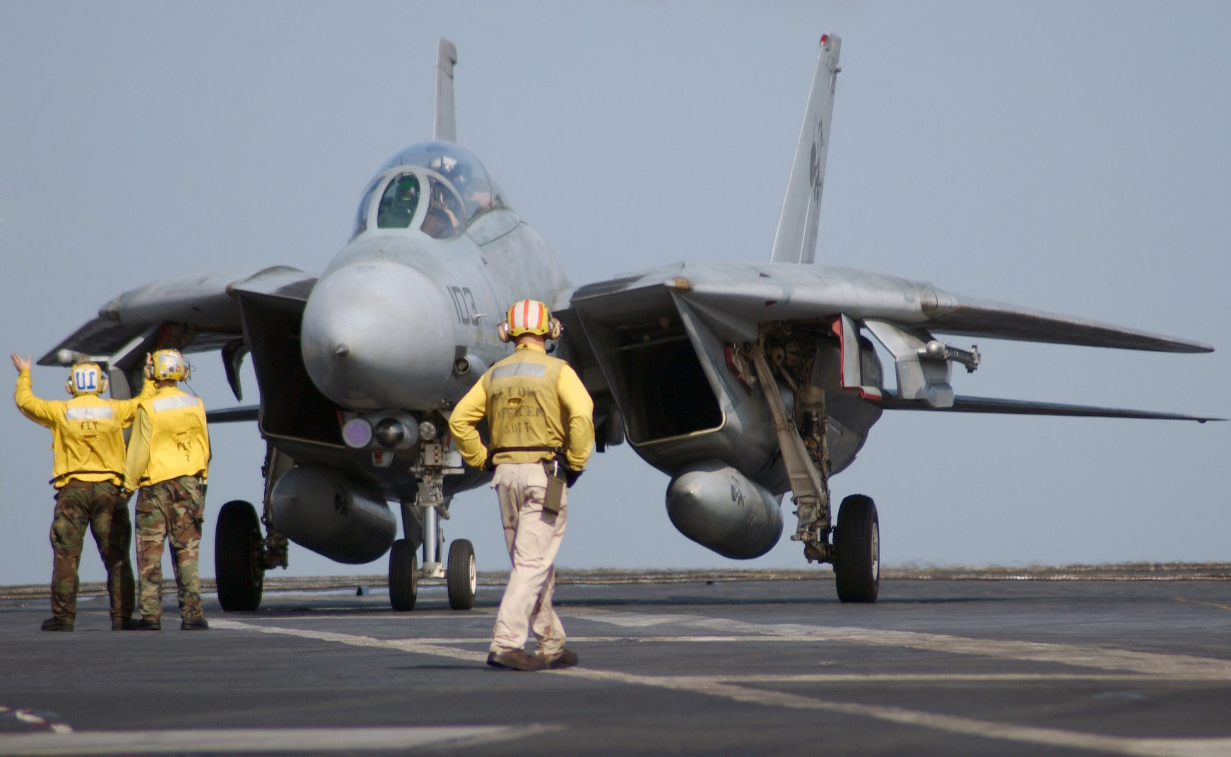 1L-002_Flight_deck_handlers_direct_an_F-14D_Tomcat_assigned_to_the_Tomcatters_of_Fighter_Squad...jpg