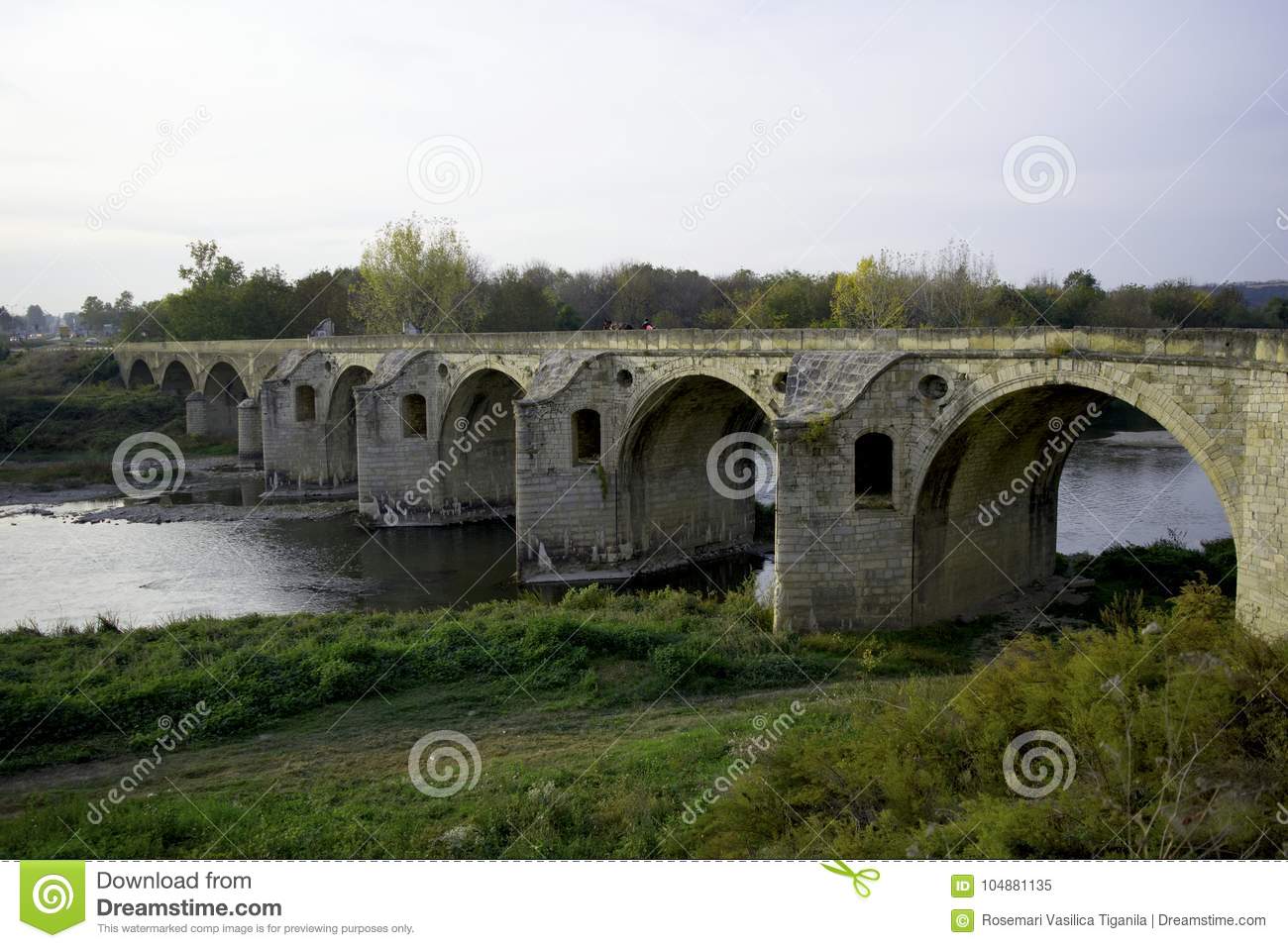 old-stone-bridge-over-large-river-old-stone-bridge-arches-over-large-river-104881135.jpg