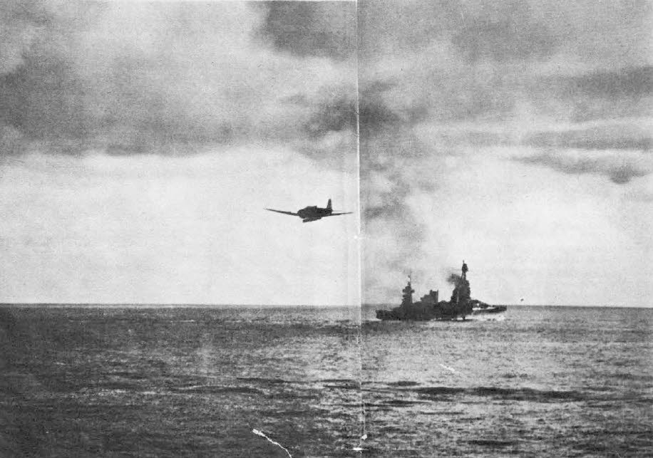 This picture shows a Nakajima B5N 'Kate' heading towards a US cruiser at the start of a torped...jpg