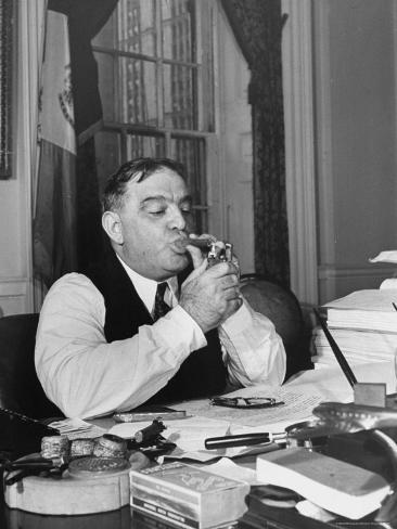 william-c-shrout-mayor-fiorello-laguardia-using-lighter-to-light-his-cigar-while-sitting-at-his-desk-in-his-office.jpg